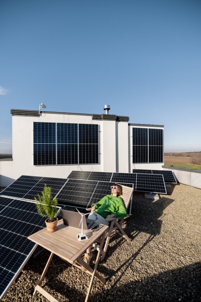 Woman works on a rooftop with a solar power plant