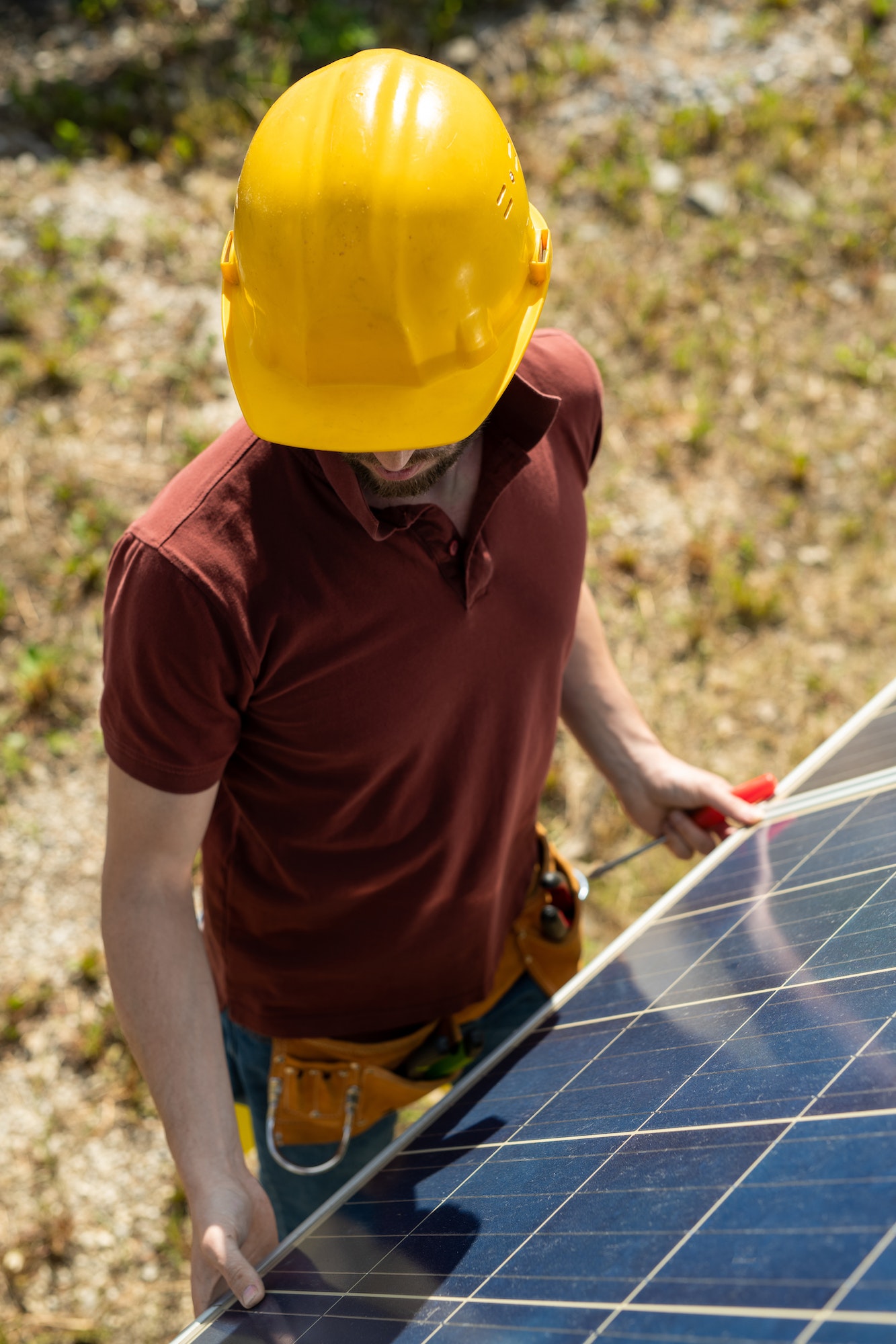 Technician Adjusting Solar Panels