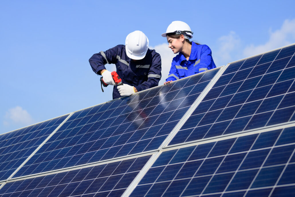 Solar panel station, Engineer installing solar panel at solar energy farm field