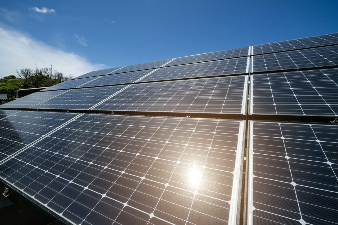 Solar panels against the blue sky with sunlight