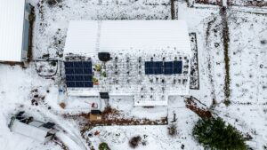 Contractors installing solar panels on a house roof winter 01