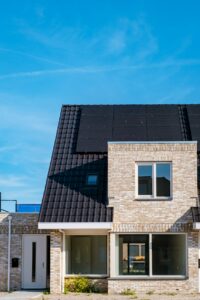 Newly build houses with solar panels attached on roof against a sunny sky Close up of solar pannel